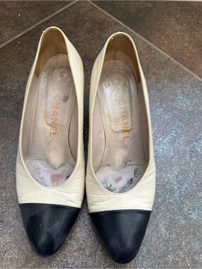 CHANEL Two-Tone Leather Cap-Toe Pumps in Cream and Black